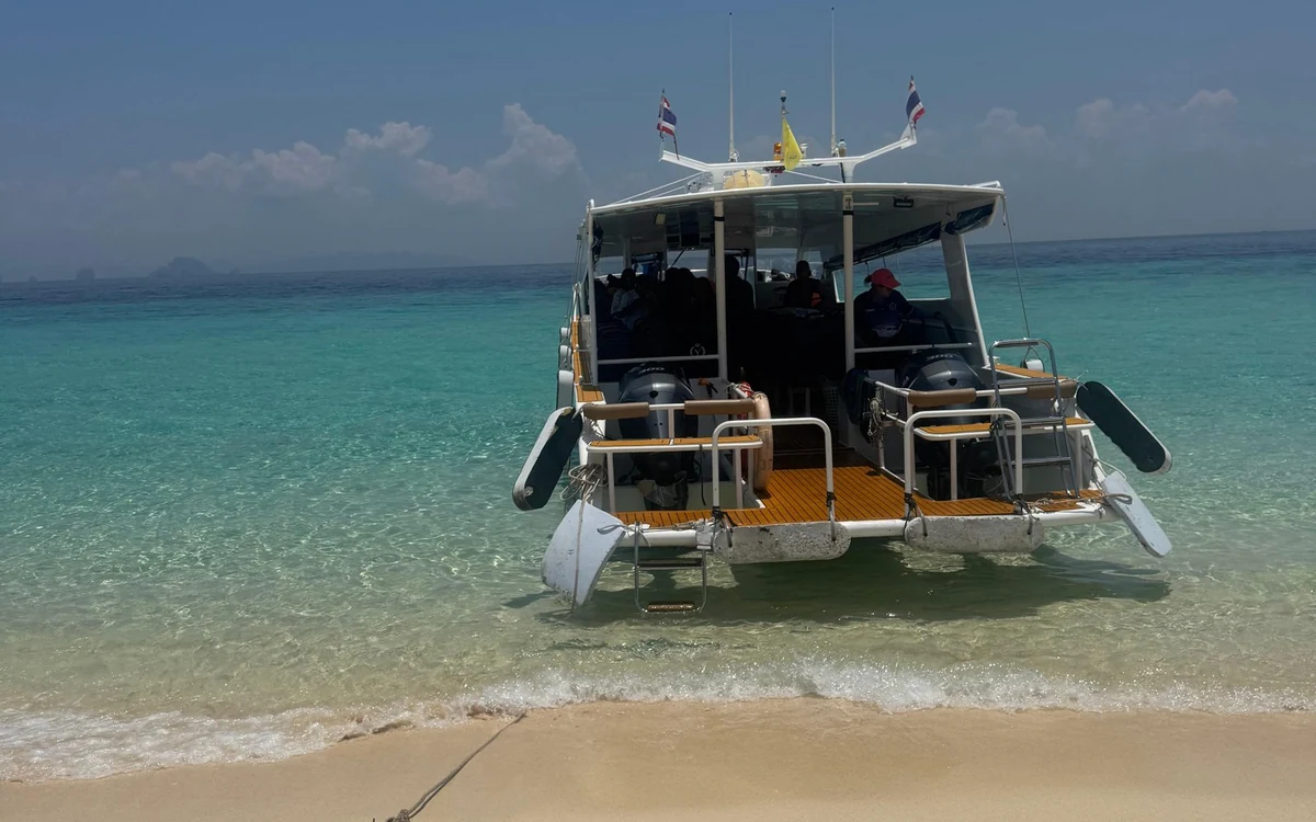 A curve of white sand and shallow turquoise water at Bamboo Island north of Phi Phi
