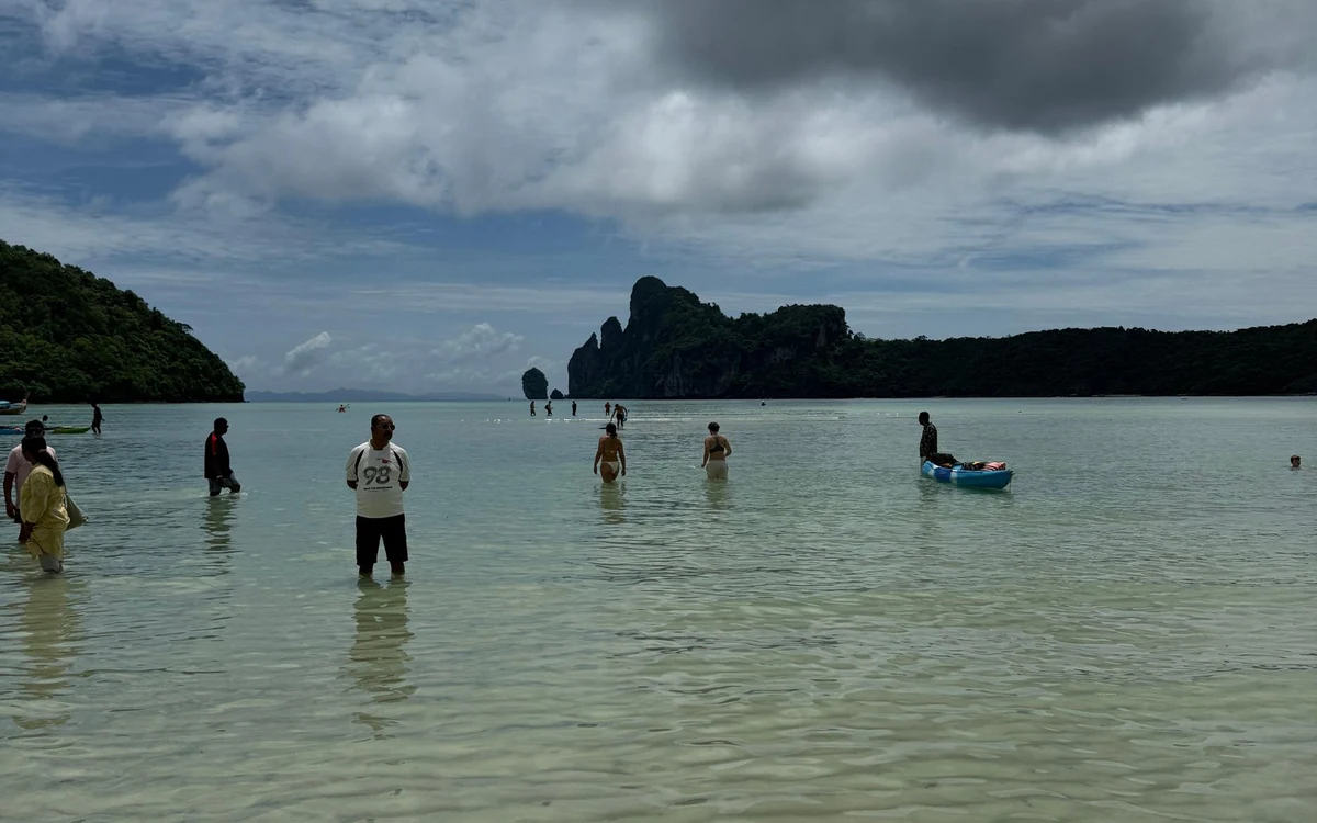 The shallow turquoise water and pale sand of Khai Island near Phuket