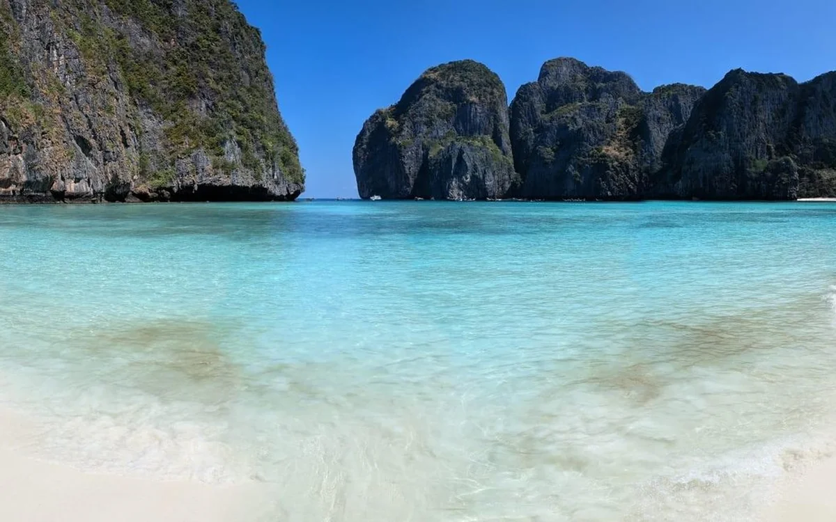 A speedboat crossing from the Krabi coast towards the limestone islands of Phi Phi