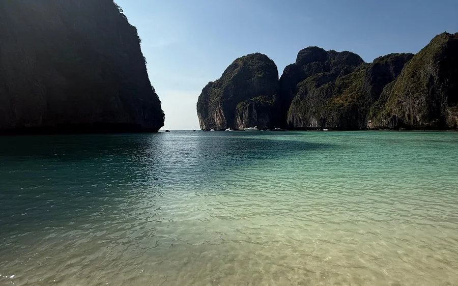 Snorkellers in clear water above coral near Phi Phi