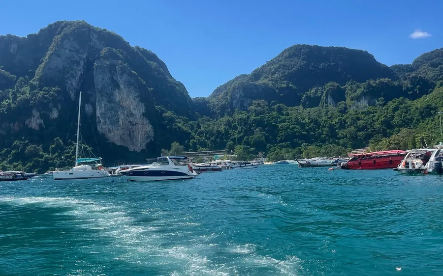 A speedboat crossing open water between Phuket and Phi Phi